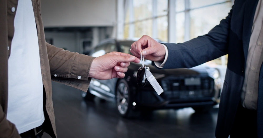 Hand passing car keys: B2B automotive marketing transition